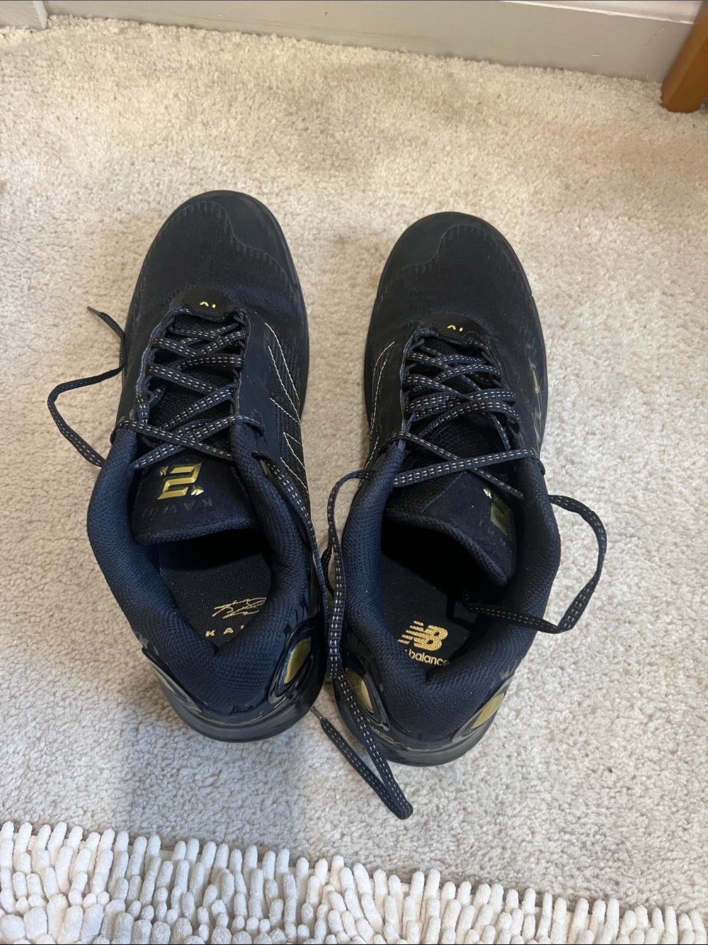 New Balance Men's Black Athletic Sneakers with Gold Accents